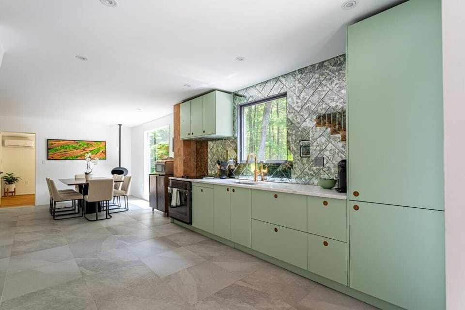 This charming mint green kitchen adds a pop of personality to your stay