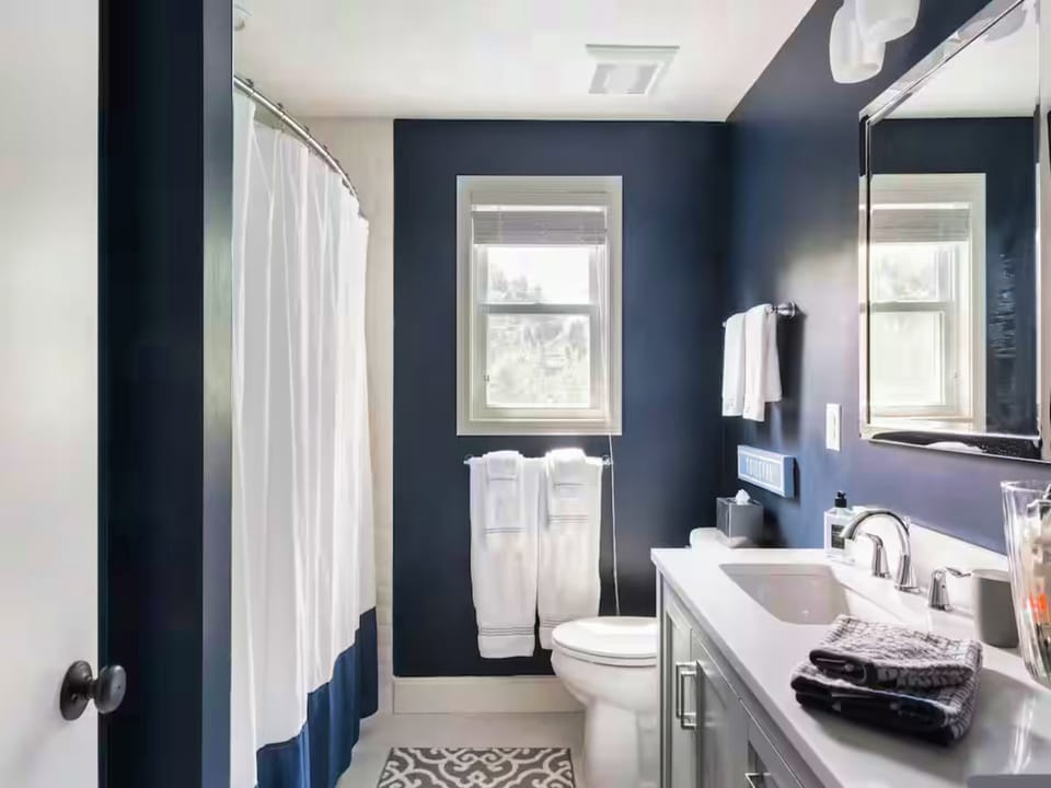 Full Bath | Features Dual Sinks, a Shower/Tub Combo, and Convenient Access for Multiple Guests