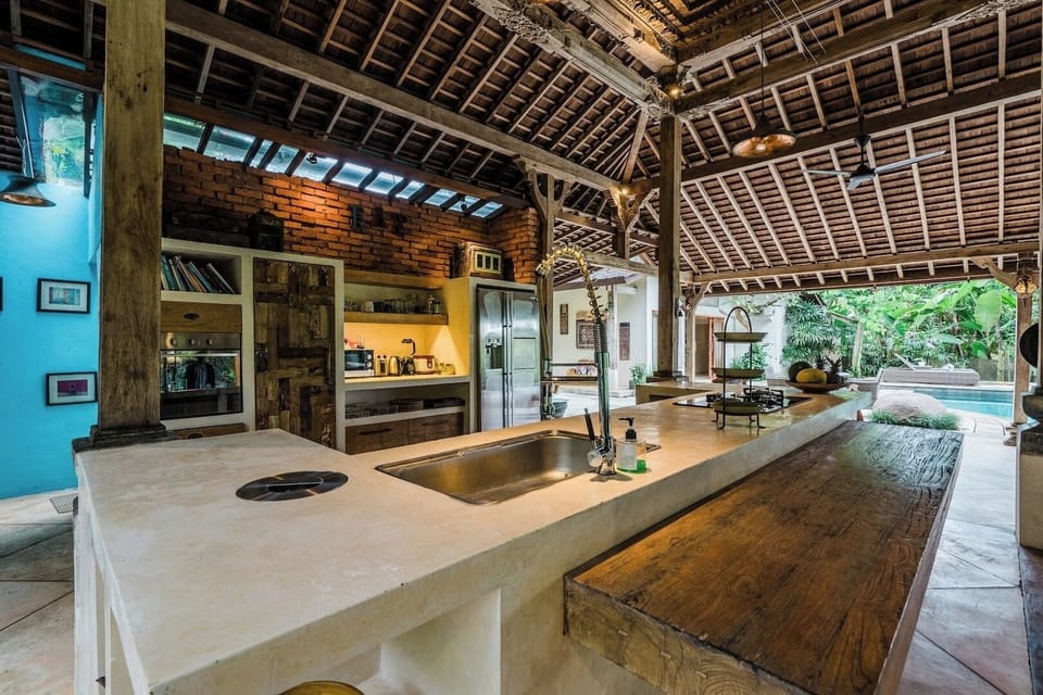 A spacious kitchen area featuring modern appliances, wooden cabinetry, and a large island. The design is both practical and stylish, perfect for preparing and enjoying meals.