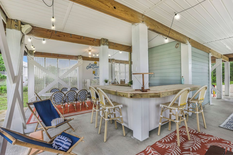 Covered outdoor bar and lounge with dining space for easy entertaining