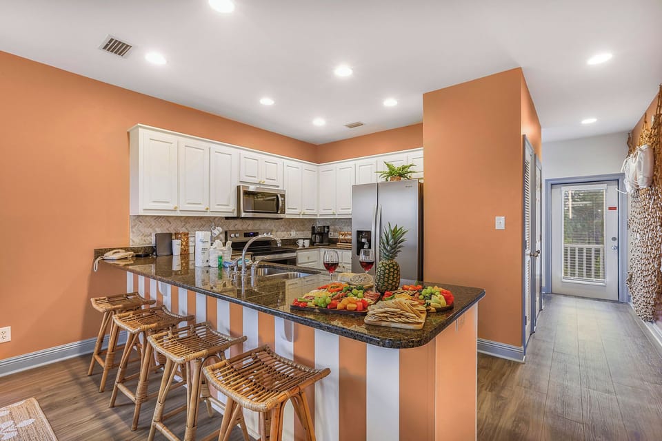 Bright open kitchen with granite island seating and stylish coastal charm