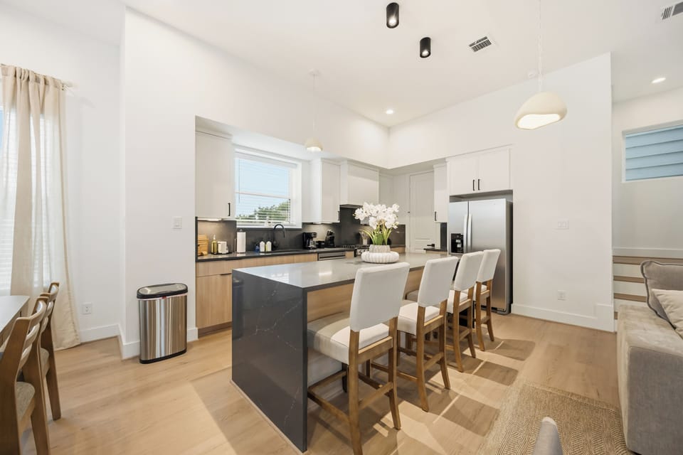 Modern kitchen featuring a center island with seating for four, perfect for casu
