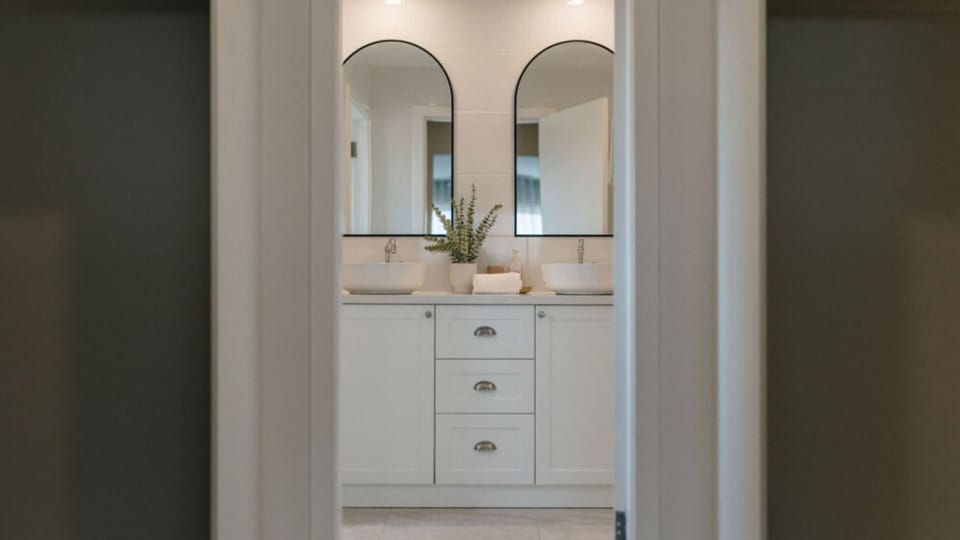 Stylish ensuite featuring a double vanity and modern finishes.