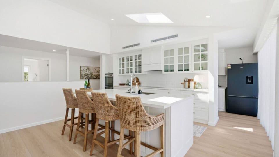 Open-plan kitchen with breakfast bar and ample workspace.