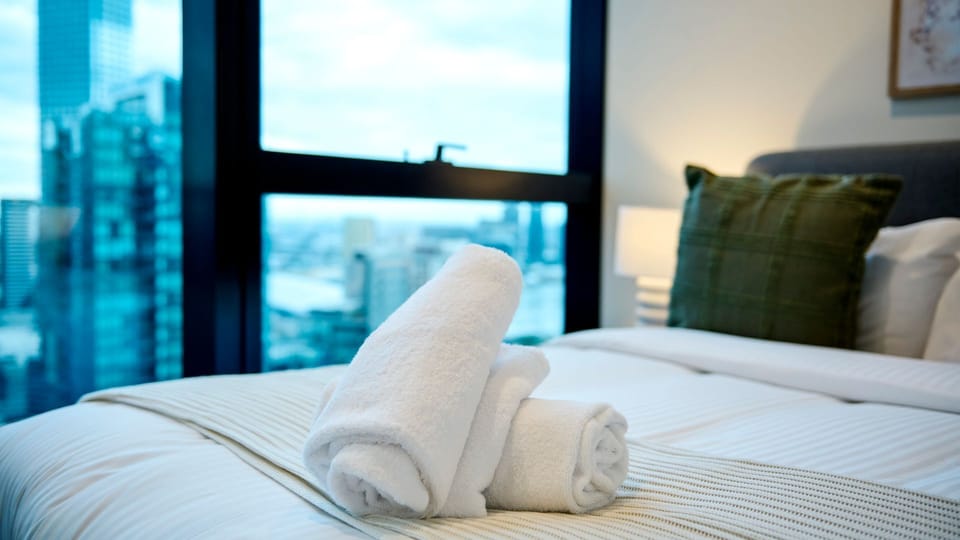 Wake up to stunning skyline vistas from this serene bedroom escape.