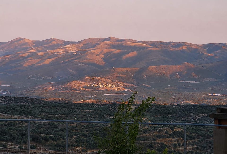 The mountain view deepens at dusk, giving your evenings a quiet Cretan backdrop above the Messara plain