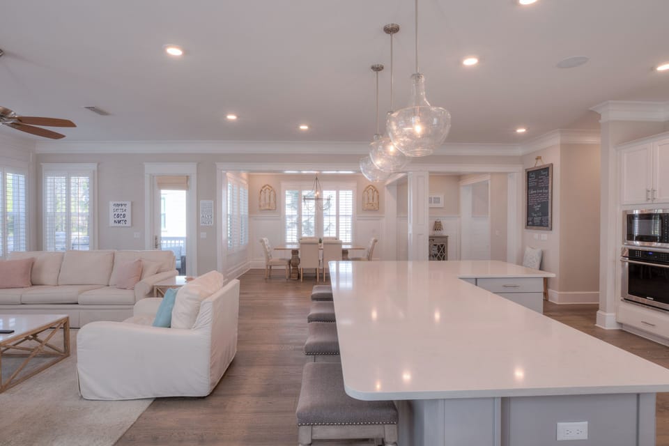 Perspective shot from the kitchen island looking into the dining and living areas.