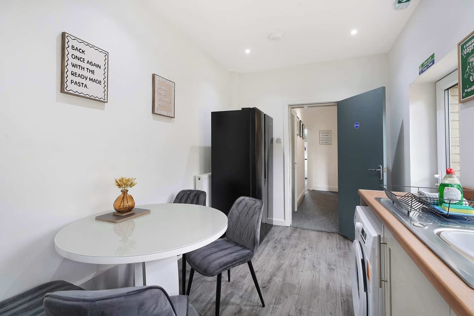 A lovely kitchen-dining spot featuring a four-person table. It’s a wonderful, versatile space built for enjoying your meals, catching up over a fresh morning brew, or planning out your daily itinerary together.