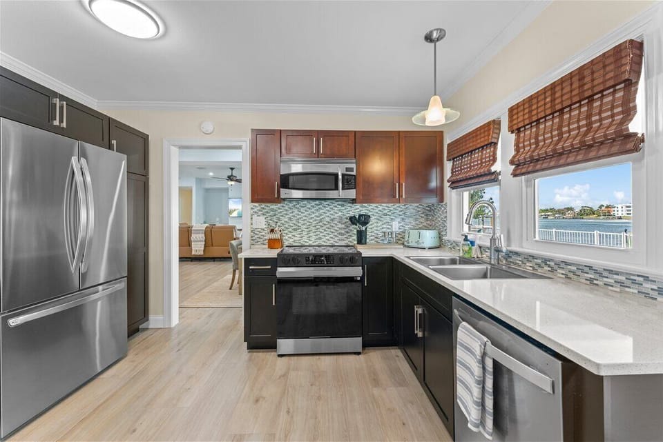 Prepare your favorite meals while enjoying peaceful waterfront views from the heart of the home in this thoughtfully designed kitchen space.