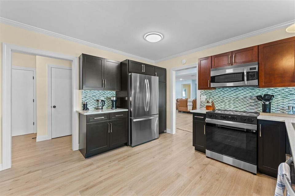 Prepare your favorite meals while enjoying peaceful waterfront views from the heart of the home in this thoughtfully designed kitchen space.