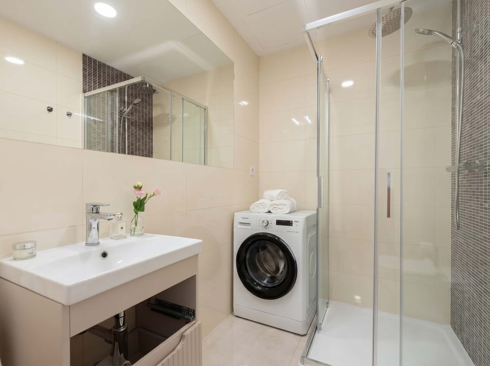 Bathroom with shower and washing machine