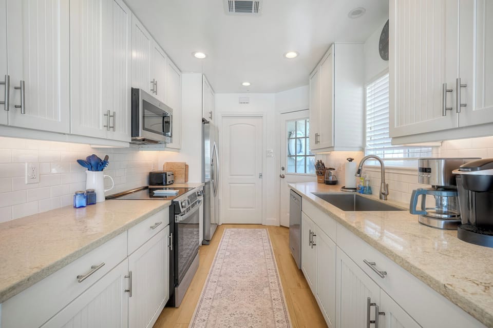 Bright galley kitchen with modern appliances