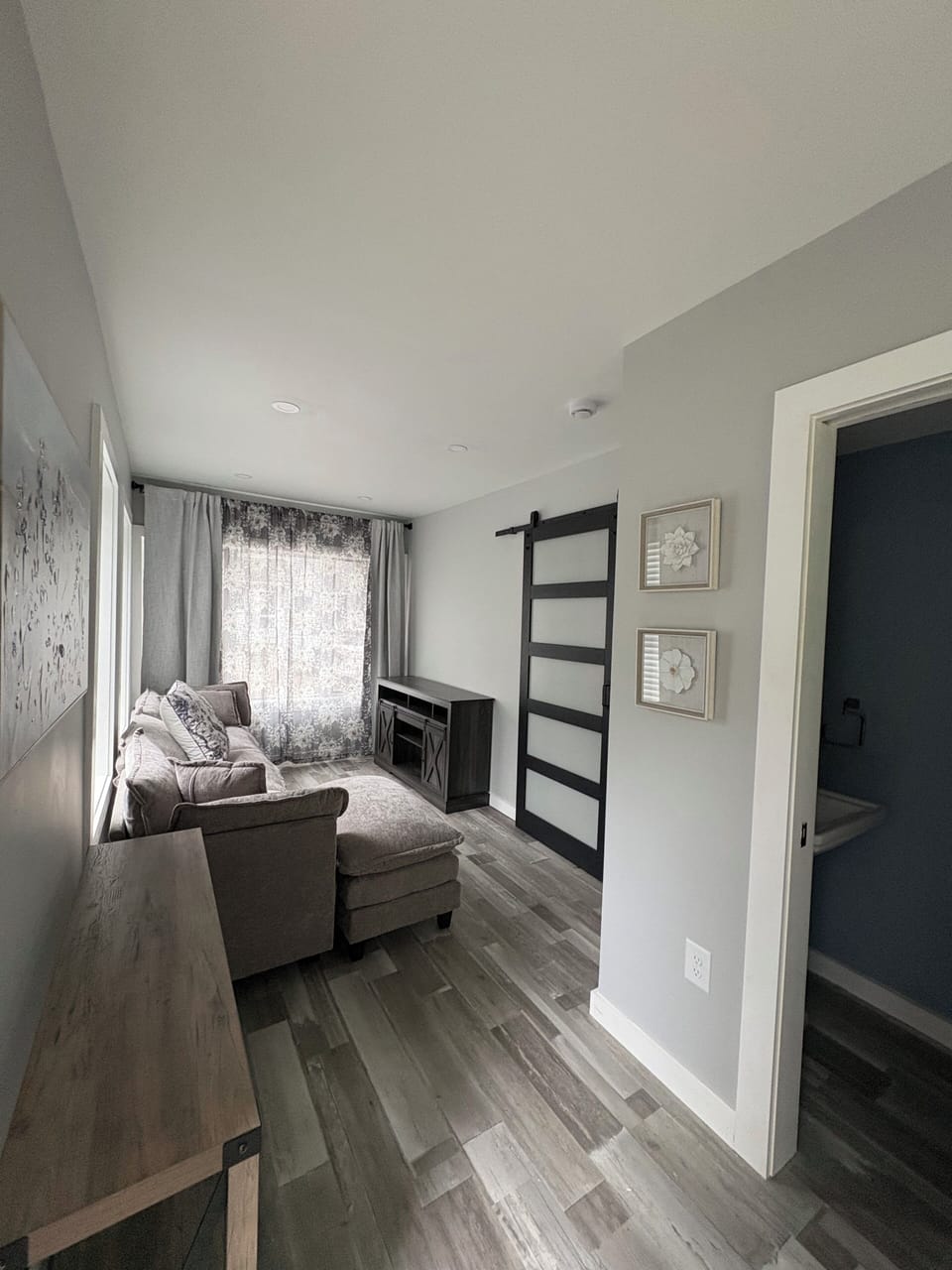 First floor living area & half-bath.  Large smart TV included not yet pictured