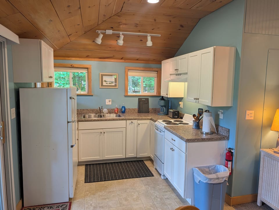 KITCHEN: The accommodating kitchen suited with a fridge, an oven, a toaster, a coffeemaker, and other kitchen essentials