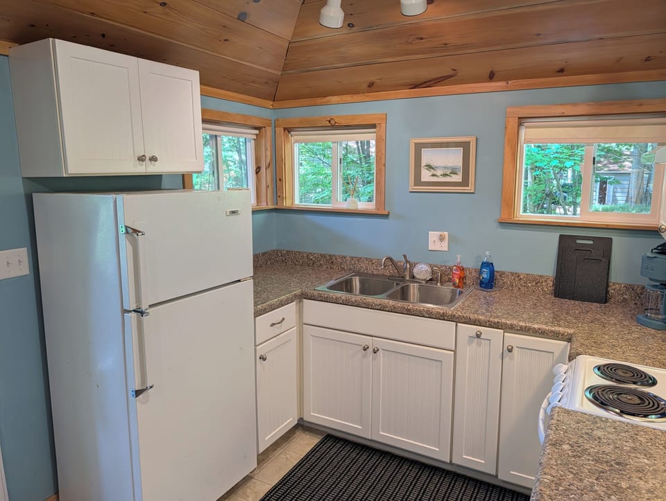 KITCHEN: The accommodating kitchen suited with a fridge, an oven, a toaster, a coffeemaker, and other kitchen essentials