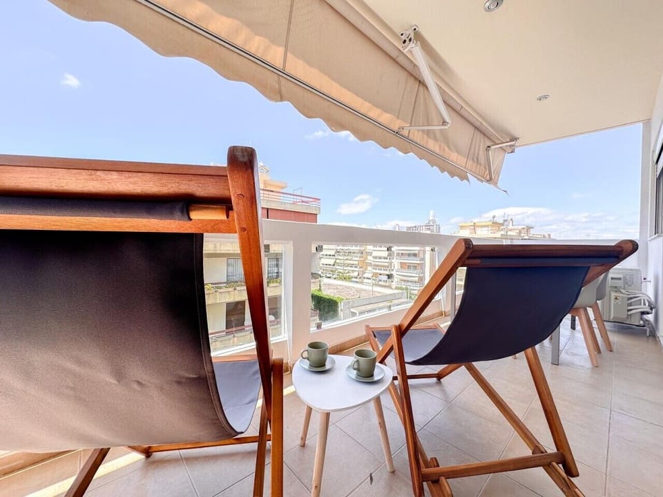 Shaded balcony with seating and open city views
