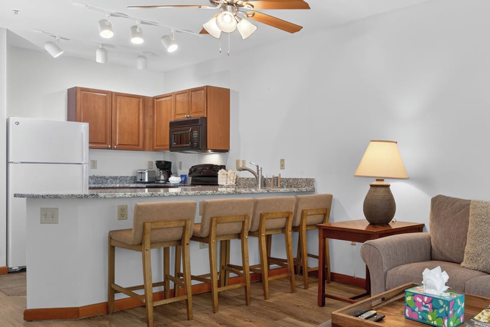 Your kitchen connects seamlessly to the living area, with granite countertops, modern appliances, and breakfast bar seating for casual meals or morning coffee. Perfect for unwinding after a day of adventure.