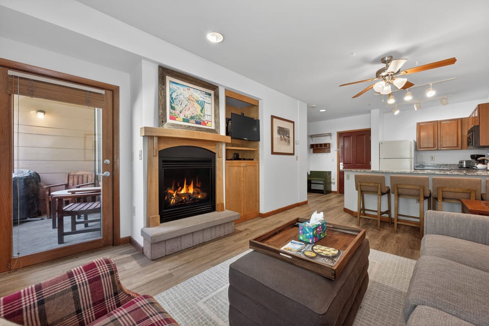 Unwind by the glowing fireplace after a day of adventure. Your open living space flows seamlessly into a fully equipped kitchen, perfect for preparing meals together.