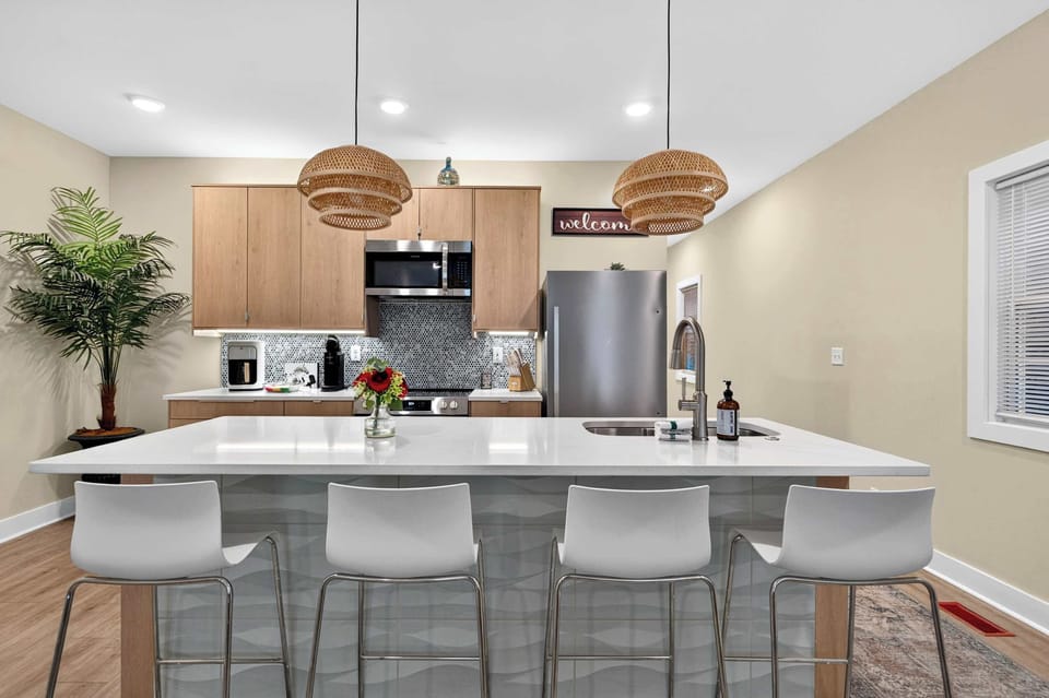 Kitchen - Unit 1: Bright and fully equipped kitchen with modern appliances, ample counter space, and everything you need to cook a comfortable meal during your stay.