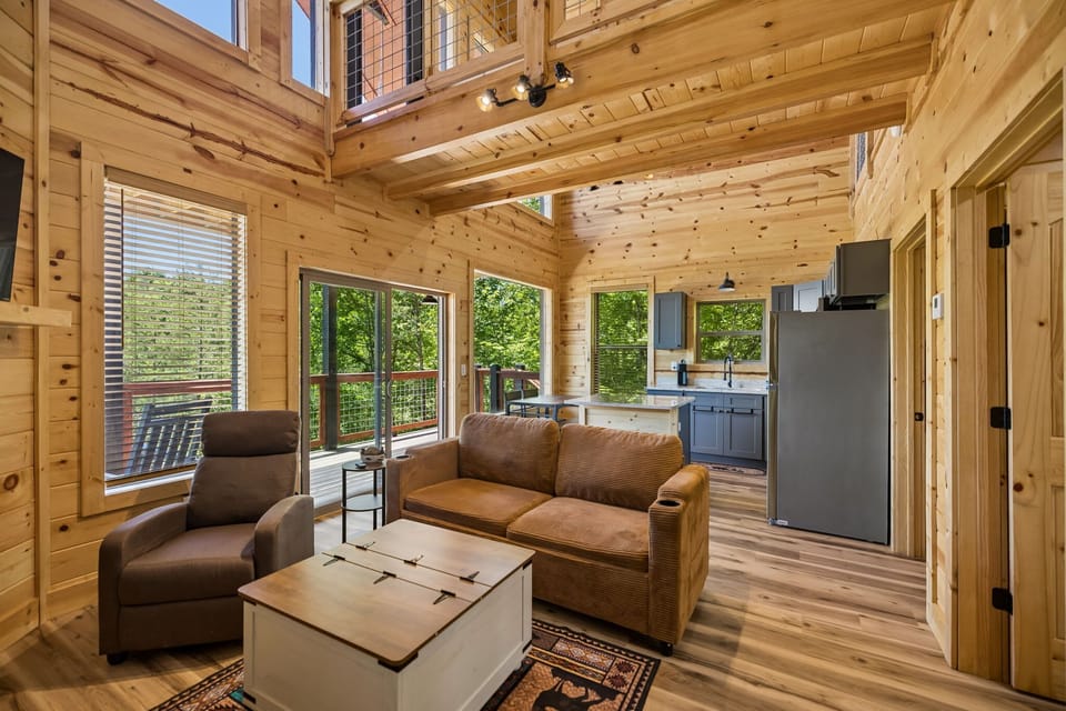 Living Room: Cozy cabin living room featuring comfortable seating, warm wood accents, and the perfect space to relax after a day of adventure.