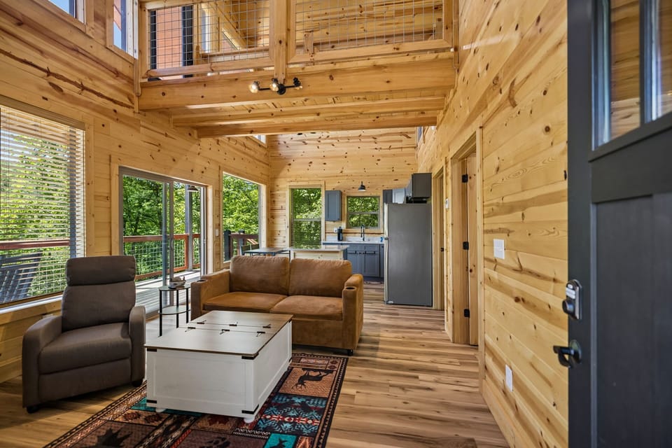 Living Room: Cozy cabin living room featuring comfortable seating, warm wood accents, and the perfect space to relax after a day of adventure.