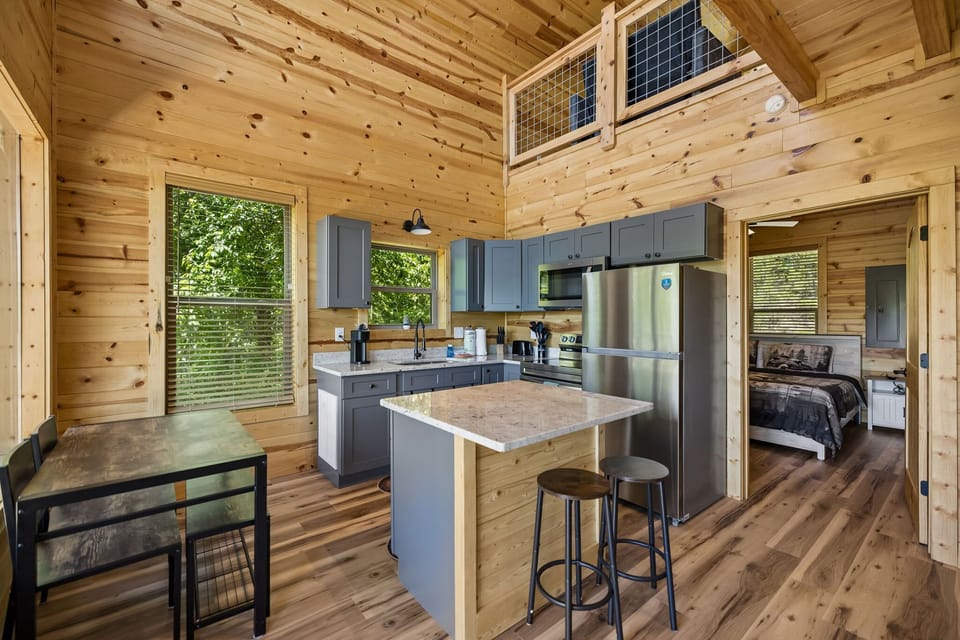 Kitchen: Bright and inviting kitchen with modern conveniences and cozy cabin charm, perfect for preparing meals after a day of exploring.