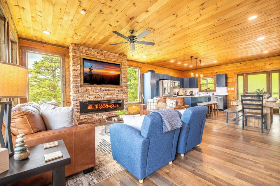 Imagine relaxing in this inviting open-concept living space with soaring wood ceilings, cozy fireplace, and modern kitchen—your perfect home away from home.