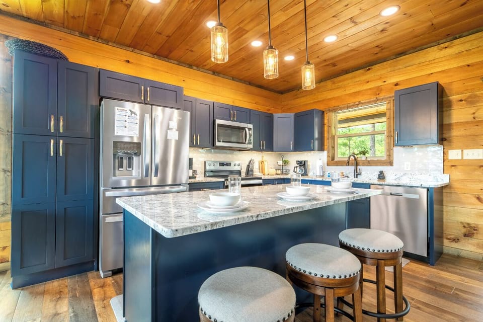 Your fully-equipped kitchen features modern stainless steel appliances, granite countertops, and a spacious island perfect for meal prep or morning coffee with loved ones.