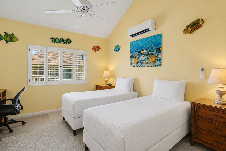 Your bright coastal retreat features twin beds, tropical charm, and cool comfort with air conditioning. Cheerful ocean decor and vaulted ceilings create a relaxing space for your getaway.