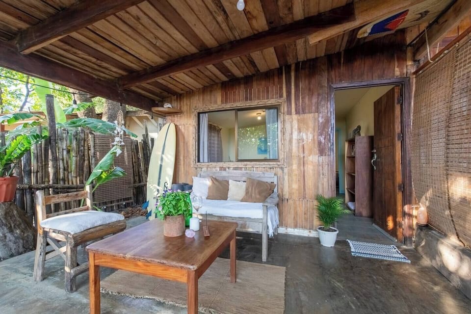Front porch with ocean view    A couch, table and side chair 