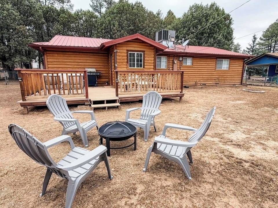 Gather around the fire pit under the pines or enjoy outdoor dining and grilling in the fully fenced backyard