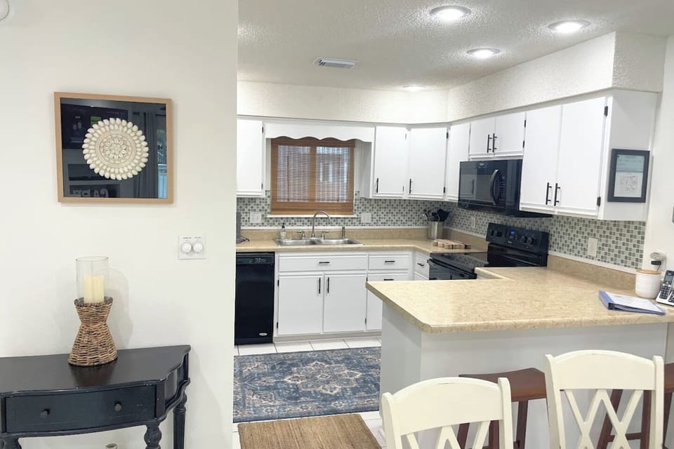Cook a proper meal without bumping elbows — the kitchen has everything you need, including stainless appliances and a full spice rack already stocked.