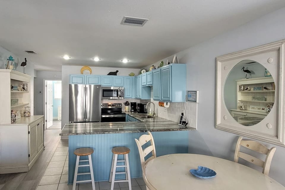 Cook the real vacation meal here — stainless steel appliances, updated surfaces, and a hutch stocked for storing your groceries.
