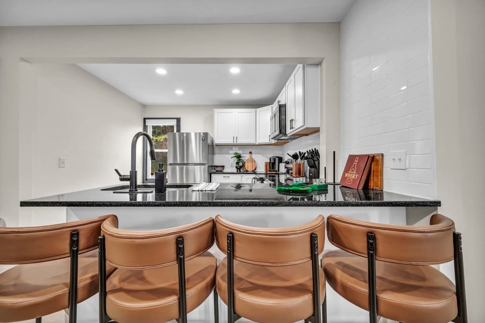 Kitchen island w/ bar seating & pendant lighting, great for casual meals or chatting.