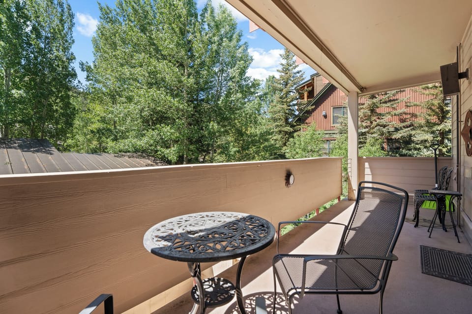 Your private balcony offers a peaceful retreat with outdoor seating and treetop views, perfect for morning coffee or evening relaxation surrounded by mountain greenery.
