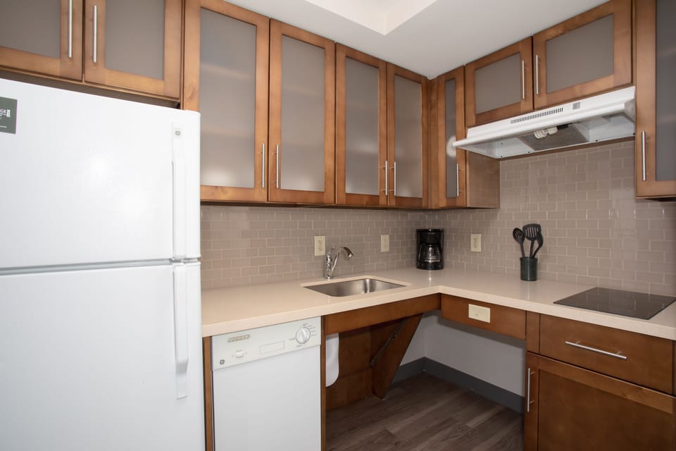 Functional kitchen equipped with a refrigerator and modern features.