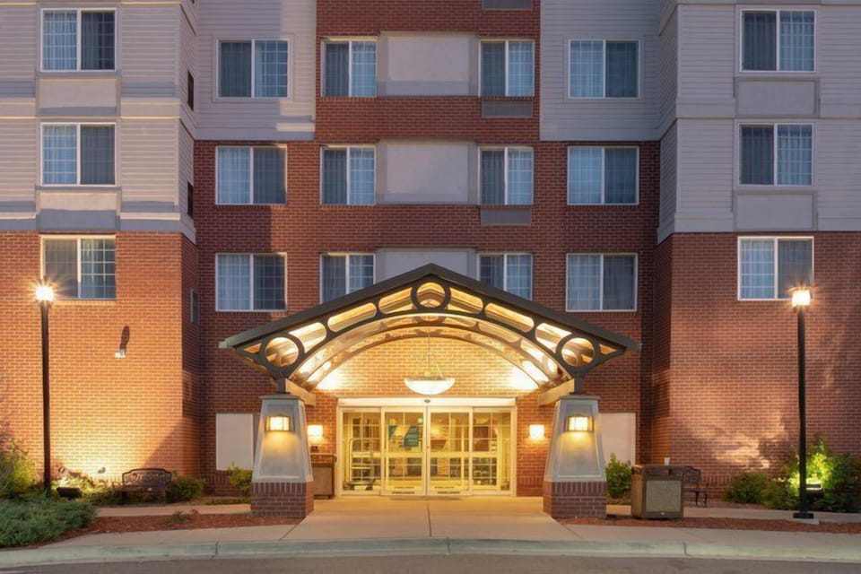 Exterior of the hotel building with surrounding grounds.