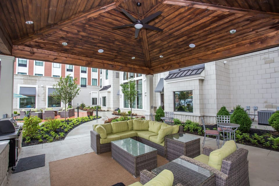 Relax under a charming gazebo, surrounded by lush greenery and comfortable seating for unwinding.