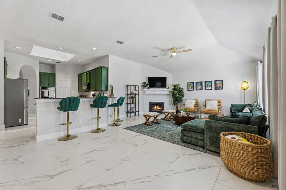  Cozy up by the fireplace or pull up a stool at the bar — this open layout has a spot for everyone!