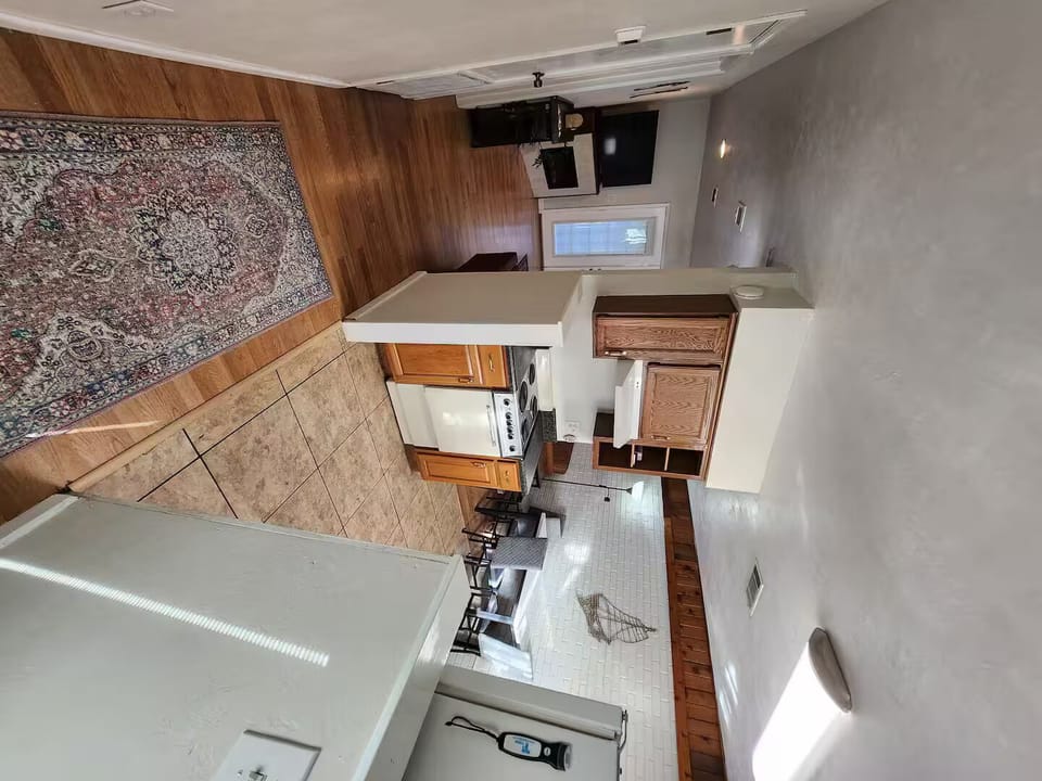 microwave, kitchen visible, indoor, kitchen, stovetop, daytime