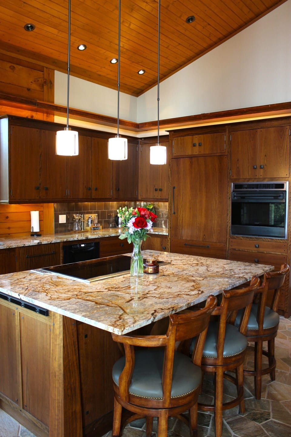 Large kitchen island with stove and 3 bar stools