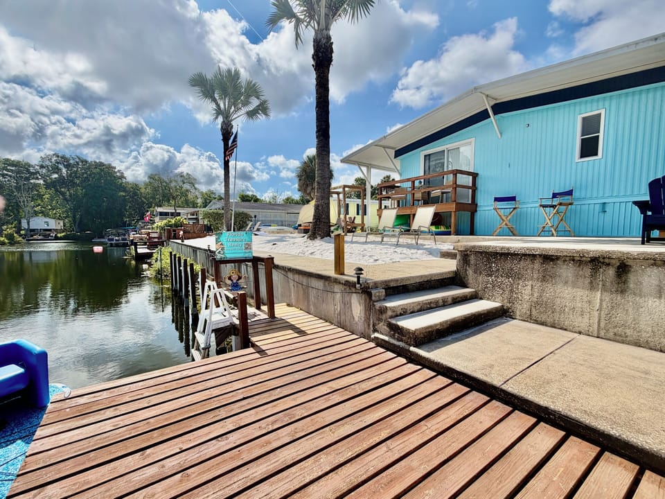 Backyard dock with  easy access ladder, balcony off primary bedroom.