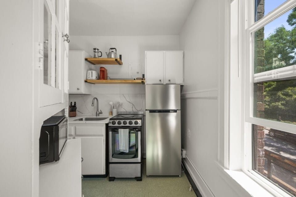 Bright and efficient kitchen featuring a full-size refrigerator, gas stove, microwave, and everything needed for preparing meals during your stay.