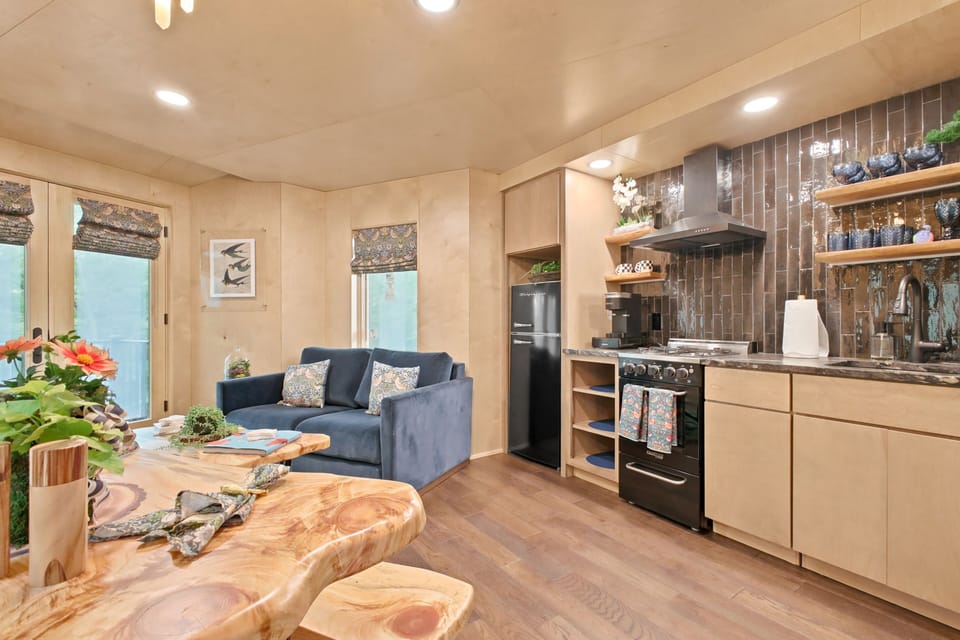 Gather in this warm modern kitchen and lounge, where designer wood details create a stylish yet inviting space to cook, relax, and make mountain memories together.