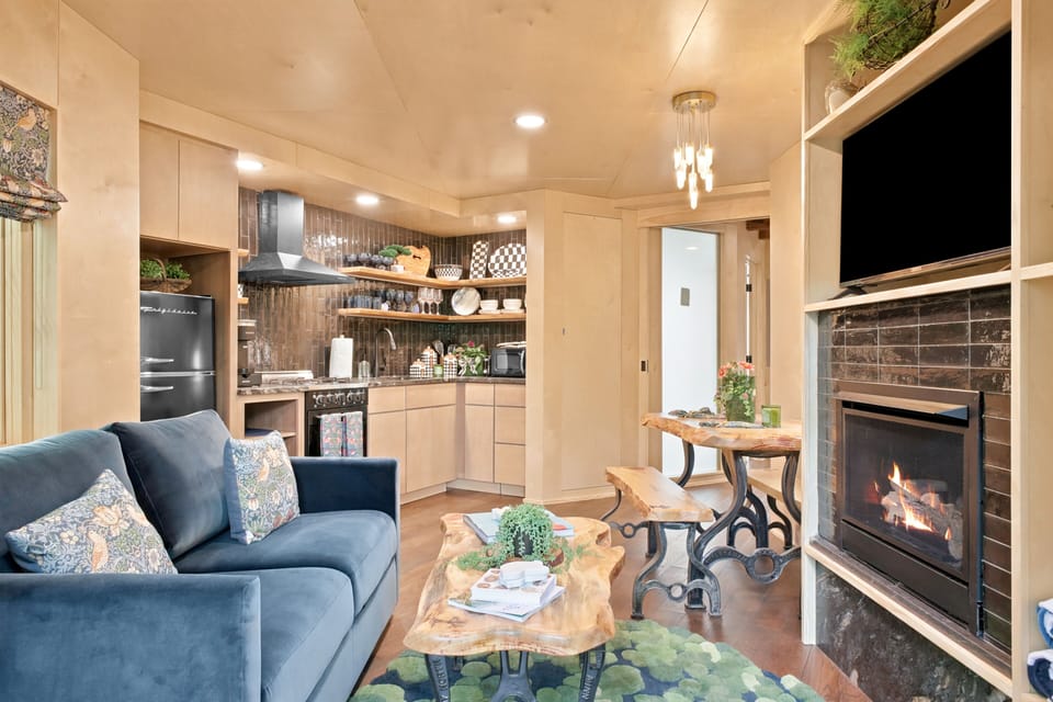 Discover this architectural forest retreat, featuring a striking elevated entry and a rooftop deck that puts the surrounding mountain views on full display.