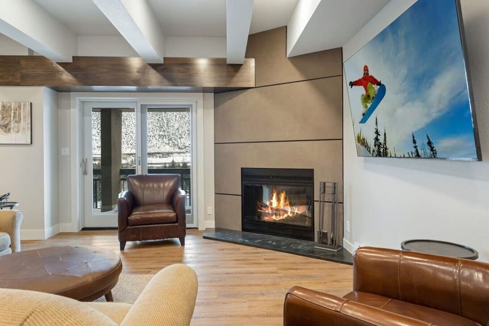 Living room featuring an indoor fireplace and smart TV