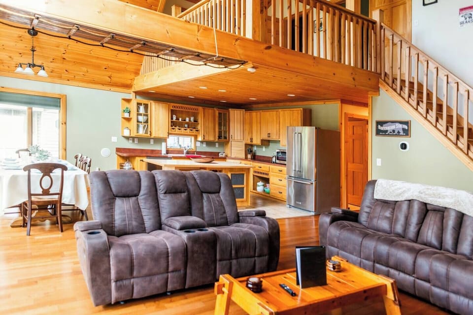 Relax and unwind at Treetop Lodge - your luxurious rustic family retreat! Enjoy the spacious open-concept living room, fully equipped kitchen, and charming loft-style design — perfect for your next peaceful, fun, family getaway!