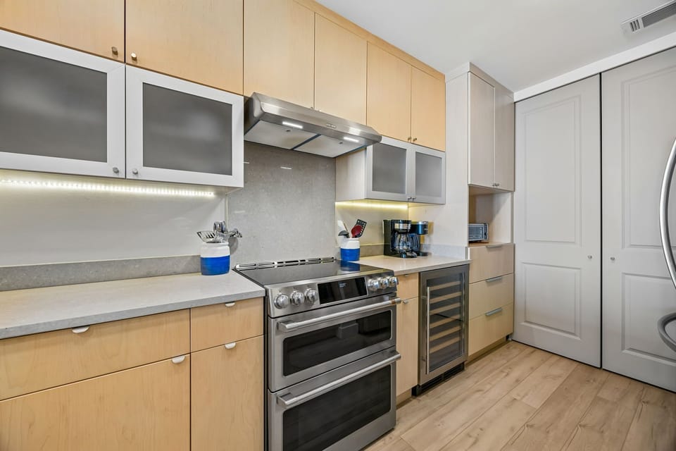 Spacious Modern Kitchen with Stainless Steel Appliances, Induction Stove, Wine Cooler, and Large Walk In Pantry