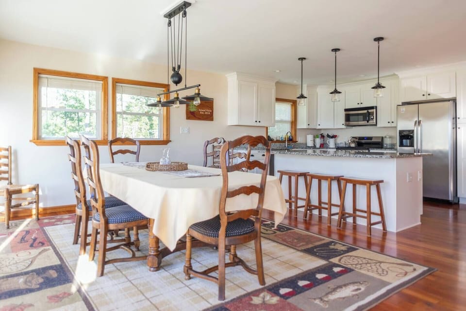 Tons of natural light from the 4 sliding doors to the deck.

Plenty of space to play games, cook and chat.

And the view of the lake from the dining room table is amazing! 