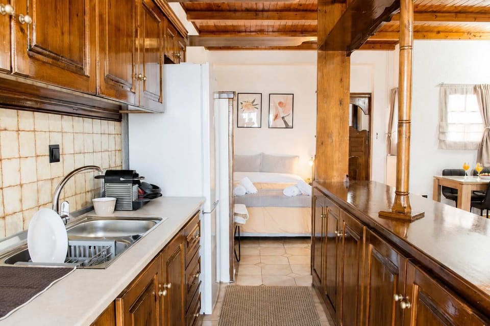 Prepare everything from quick snacks to family dinners in the fully equipped kitchen, featuring ample workspace, traditional wooden cabinetry, and all the essentials for a comfortable stay